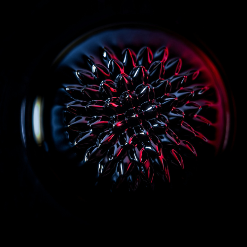 A circular sphere with red and black spikes. 